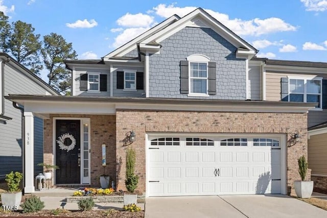 view of front facade with brick siding, driveway, and an attached garage