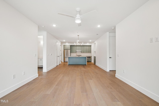 unfurnished living room featuring light wood finished floors, recessed lighting, a ceiling fan, and baseboards