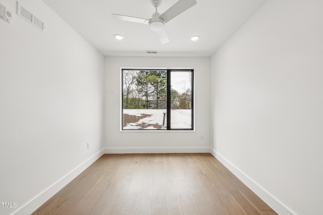 unfurnished room featuring visible vents, baseboards, and light wood-style flooring