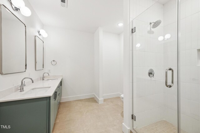 bathroom with a shower stall, baseboards, and a sink