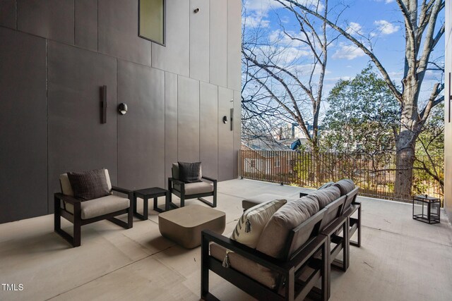 view of patio with an outdoor living space and fence