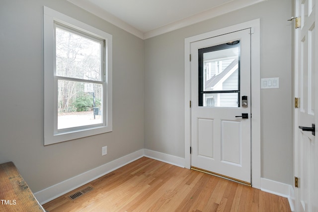 doorway to outside with visible vents, baseboards, and light wood finished floors