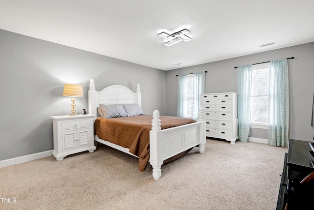 bedroom with visible vents, baseboards, and light colored carpet