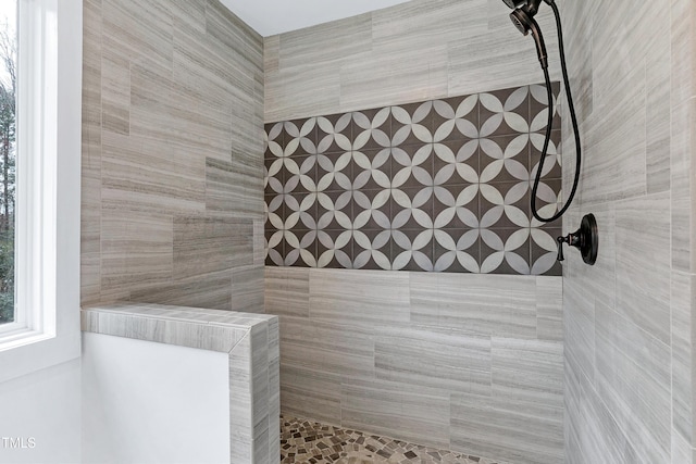 full bath with a tile shower