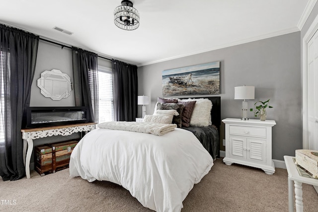 bedroom with visible vents, light colored carpet, baseboards, and ornamental molding