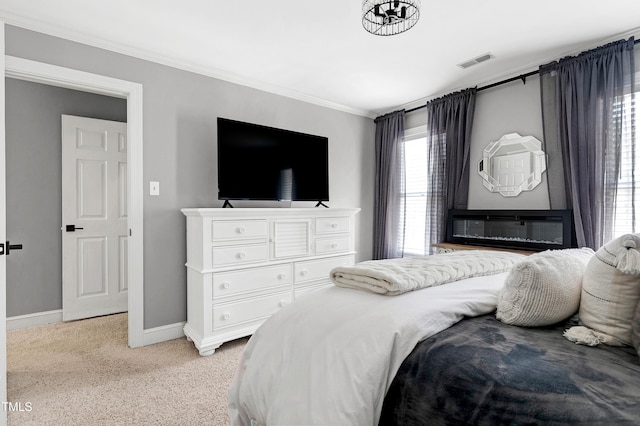 bedroom featuring ornamental molding, baseboards, visible vents, and light carpet