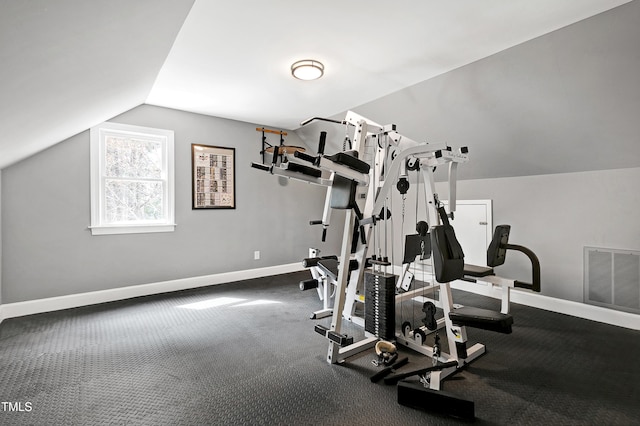 workout area featuring visible vents, baseboards, and vaulted ceiling