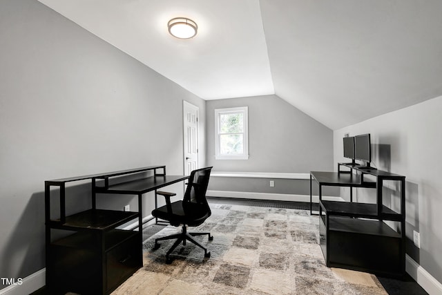 office area with baseboards and lofted ceiling