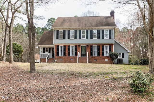 view of front of property with cooling unit, brick siding, roof with shingles, and a chimney