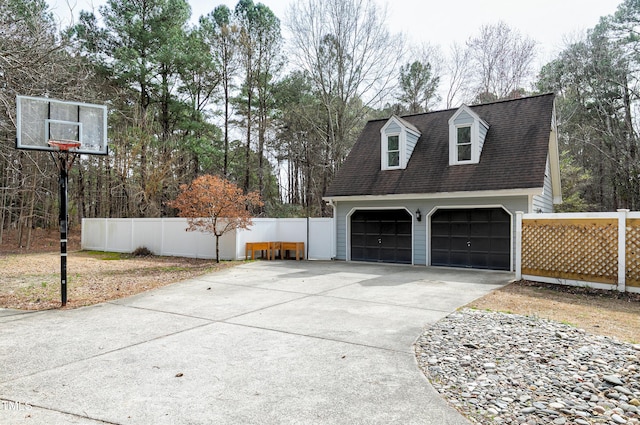 detached garage featuring fence