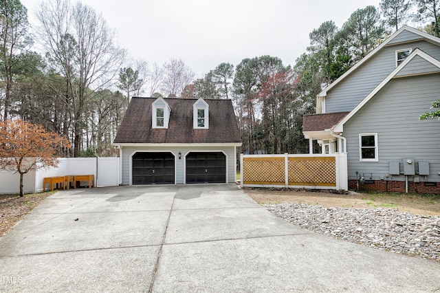 exterior space with a detached garage and fence