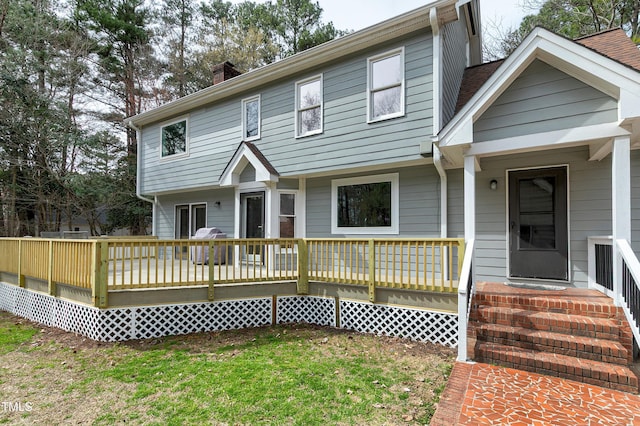 colonial house with a front yard and a chimney