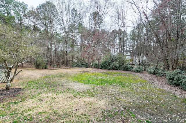 view of yard with a view of trees