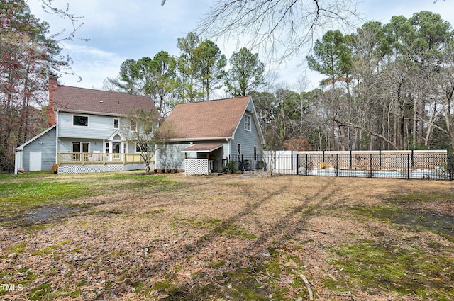 view of yard featuring a wooden deck and fence