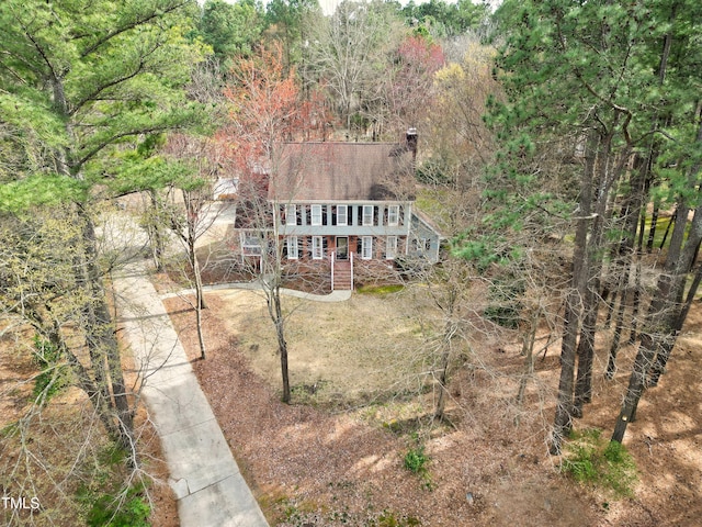 birds eye view of property with a view of trees