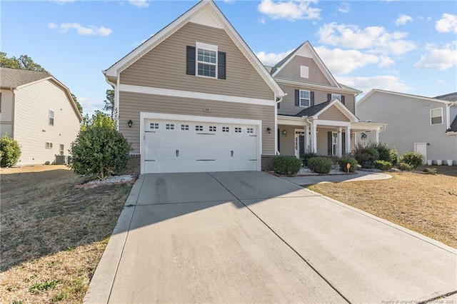 craftsman inspired home featuring concrete driveway, a porch, a garage, and a front lawn