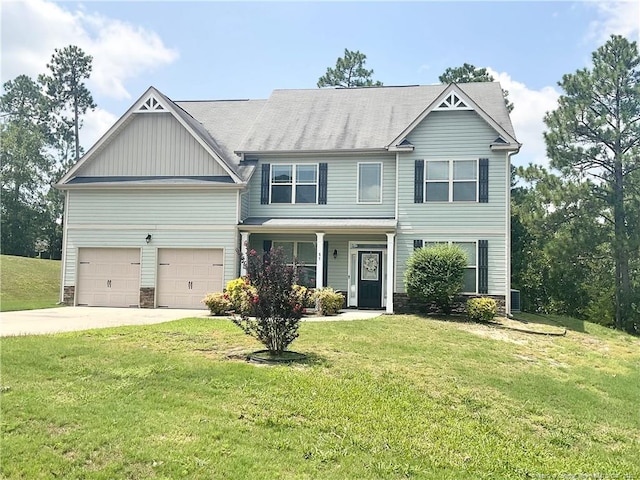 view of front of property featuring concrete driveway, a garage, and a front yard