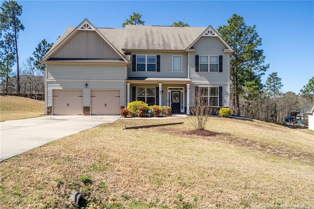 view of front facade featuring board and batten siding, a front lawn, and concrete driveway
