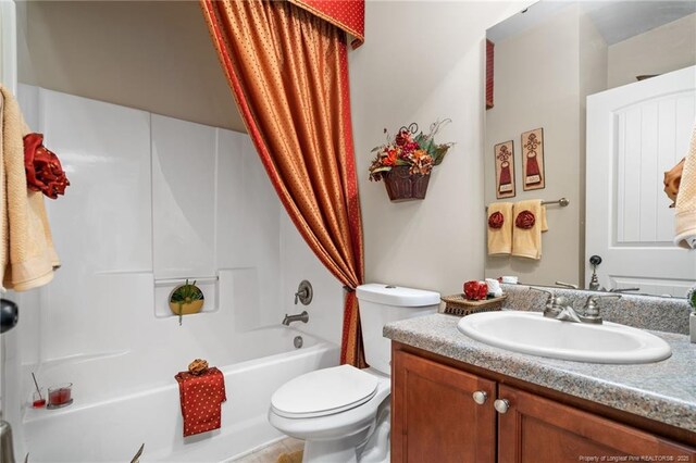 full bathroom featuring toilet, vanity, and shower / bath combo with shower curtain