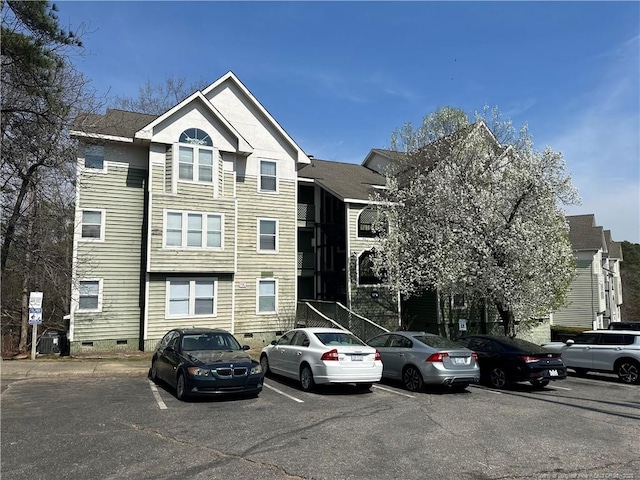 view of building exterior with uncovered parking