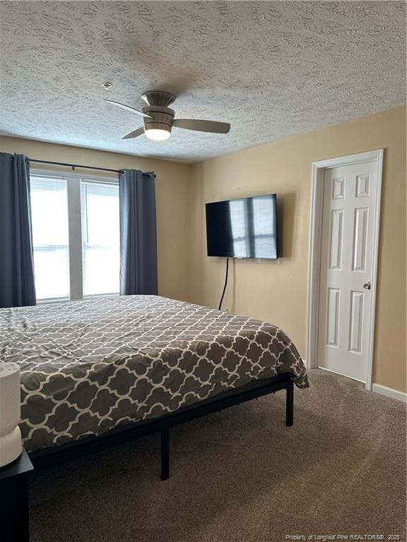 bedroom with baseboards, a textured ceiling, carpet, and a ceiling fan