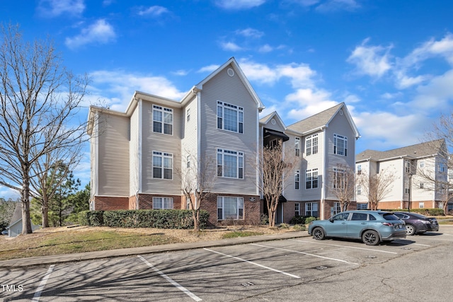 view of building exterior featuring uncovered parking