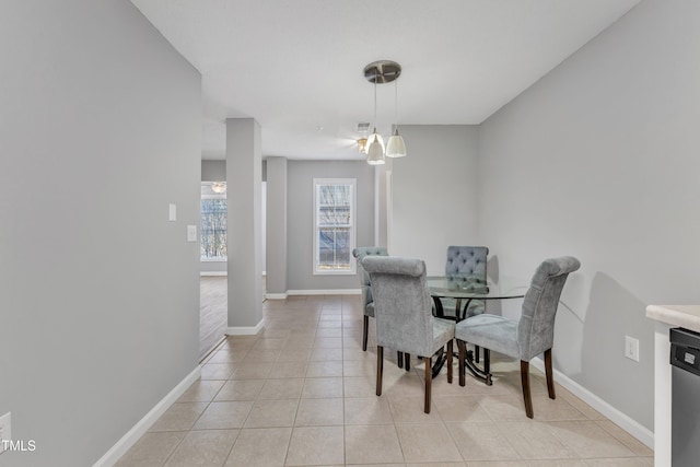 dining space with light tile patterned floors, visible vents, and baseboards