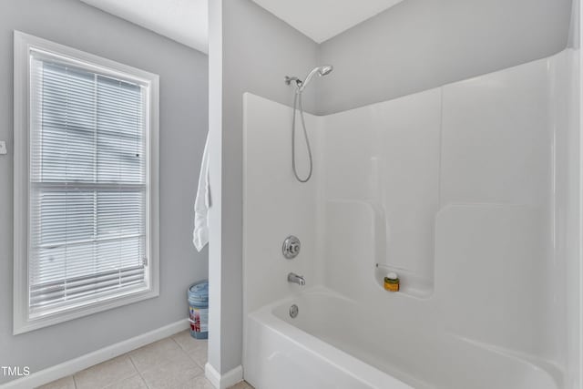 bathroom featuring tile patterned floors, shower / bath combination, and baseboards