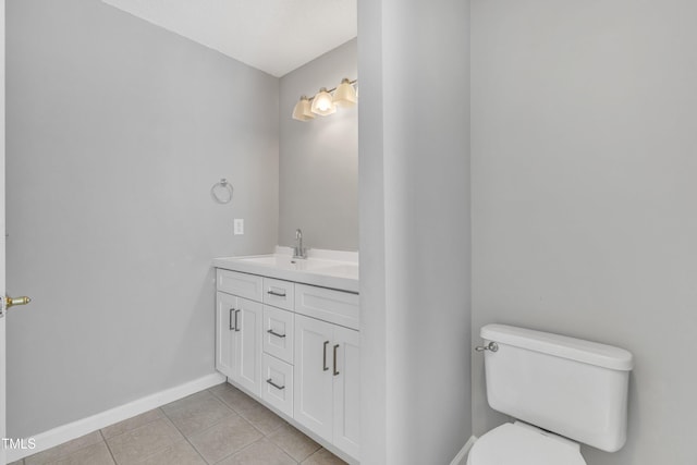 bathroom featuring tile patterned floors, toilet, vanity, and baseboards