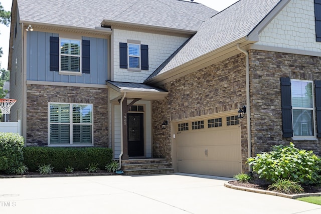 view of front of house featuring concrete driveway, an attached garage, stone siding, and roof with shingles