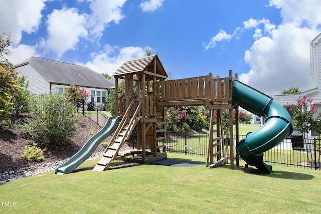 communal playground featuring a yard and fence