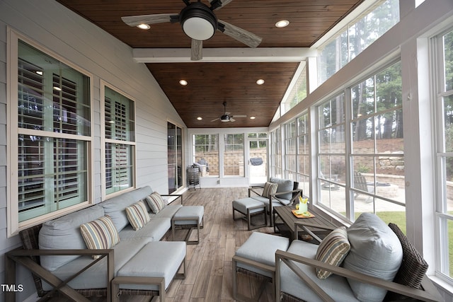 sunroom with lofted ceiling, wood ceiling, and ceiling fan