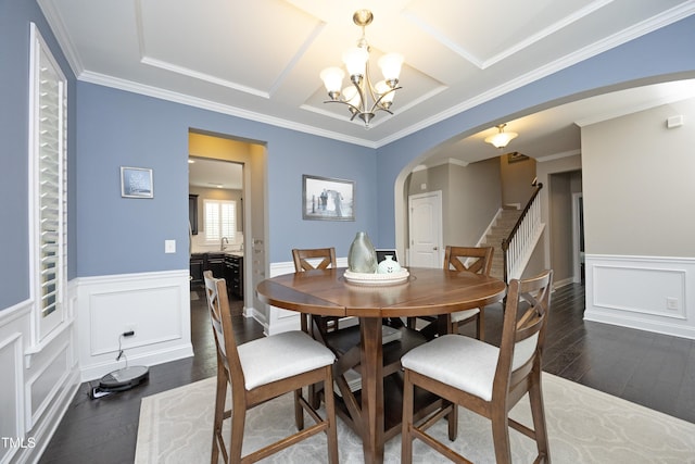 dining area with stairway, arched walkways, dark wood-style floors, and a chandelier