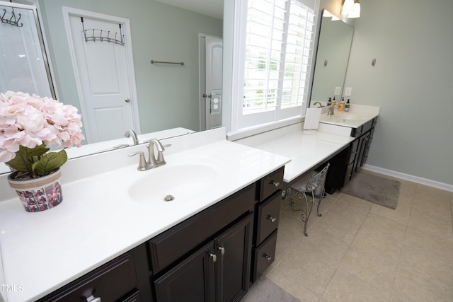 bathroom with tile patterned flooring, vanity, and baseboards