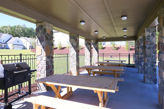 view of patio / terrace featuring outdoor dining area, a residential view, area for grilling, and fence