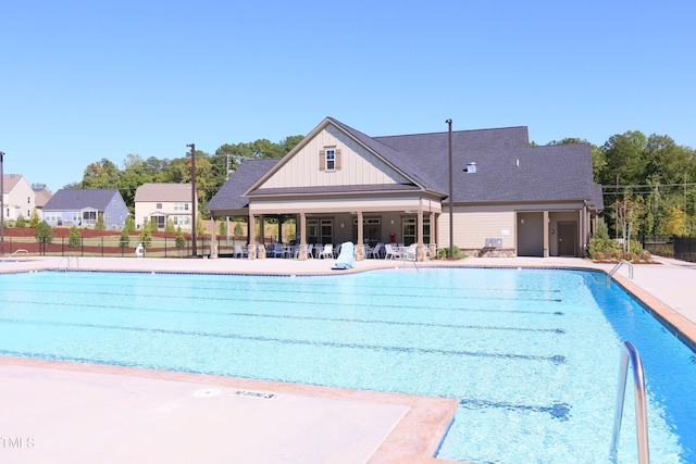 pool featuring a patio area and fence