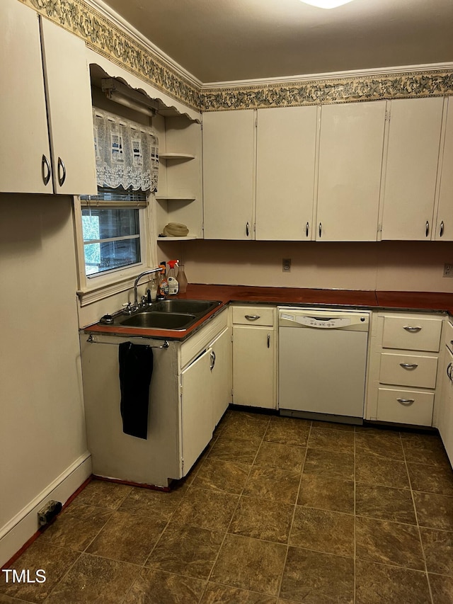 kitchen with a sink, dark countertops, dishwasher, and white cabinets