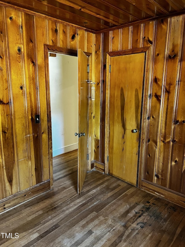 interior space with wooden walls and wood finished floors