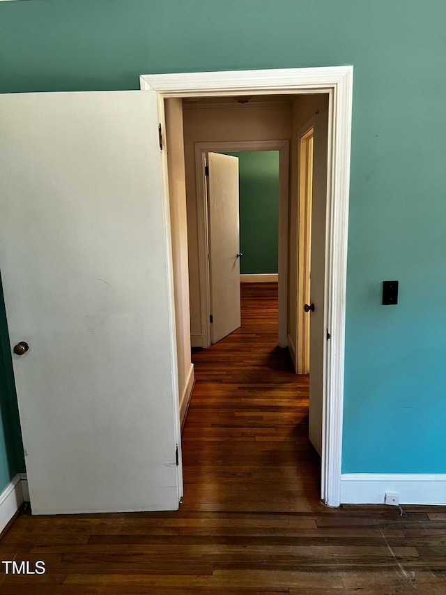 hall with wood finished floors and baseboards