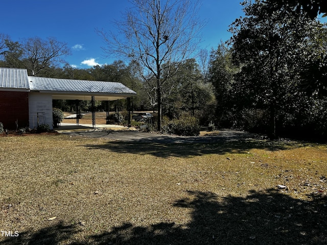 view of yard featuring an attached carport