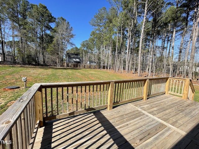 wooden terrace with a lawn