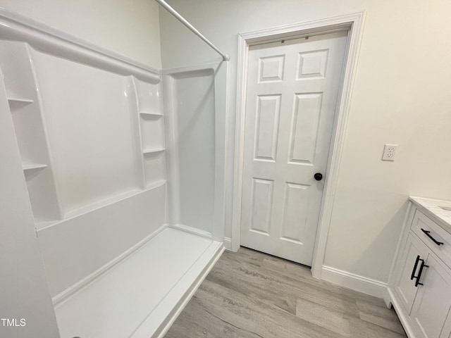 mudroom with baseboards and light wood-style floors