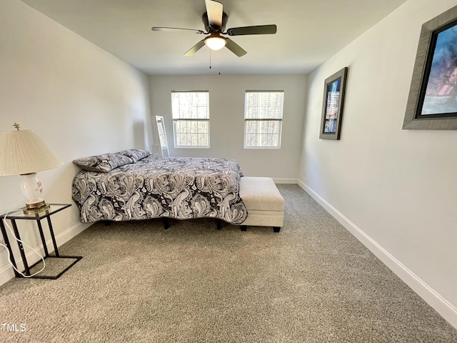 carpeted bedroom featuring baseboards and a ceiling fan