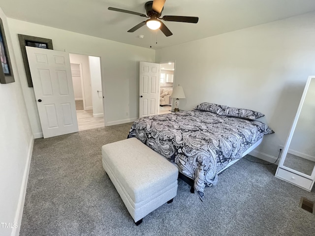 carpeted bedroom featuring visible vents, baseboards, and a ceiling fan