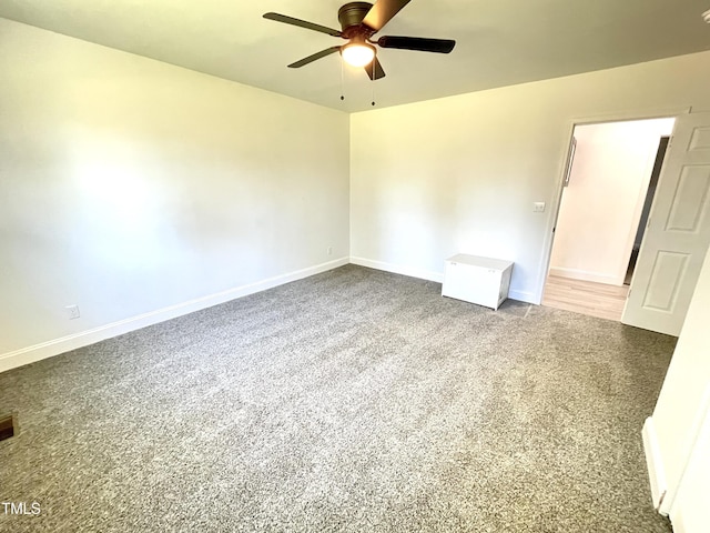 unfurnished room with visible vents, ceiling fan, carpet flooring, and baseboards
