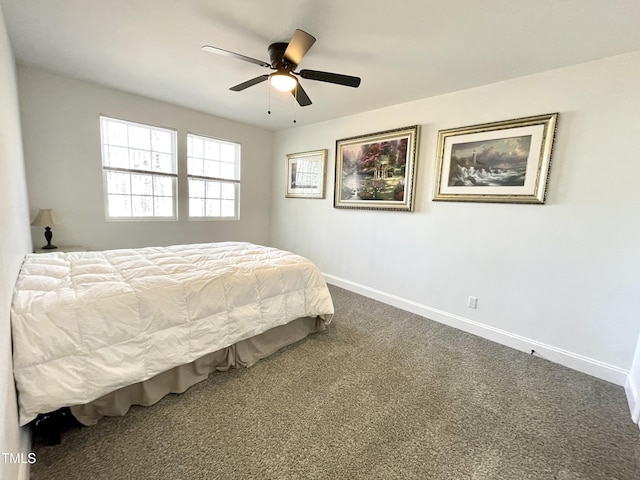bedroom with dark colored carpet, baseboards, and a ceiling fan