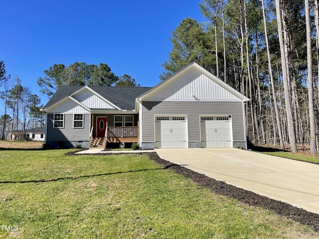 view of front facade with board and batten siding, covered porch, a front yard, an attached garage, and concrete driveway