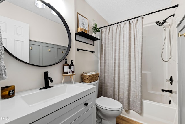 bathroom with vanity, wood finished floors, shower / tub combo, a textured ceiling, and toilet