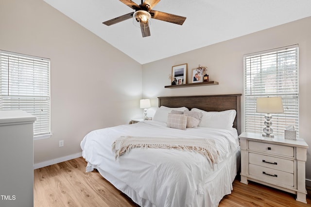 bedroom featuring baseboards, light wood-style floors, a ceiling fan, and vaulted ceiling