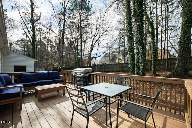 wooden deck with outdoor dining space, a grill, outdoor lounge area, and fence